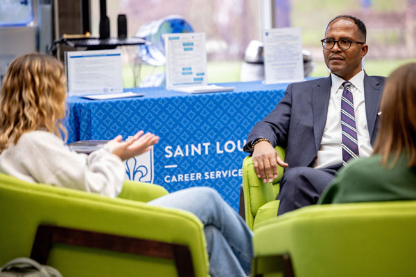 A student talks with career services staff member in SLU's Career Services Center