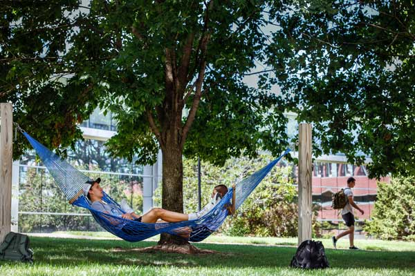 students laying on a hammock