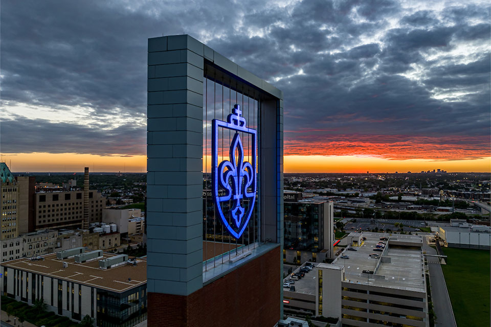 A fleur de lis on top of a building on campus.