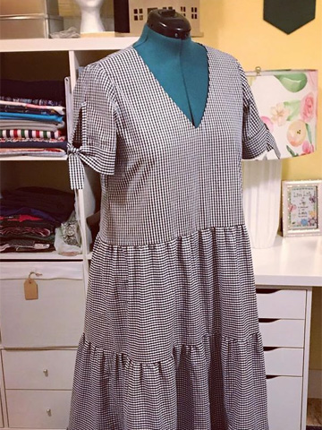 Pictured is a dress that doctor Salle sewed. It is blue and has a checkered pattern