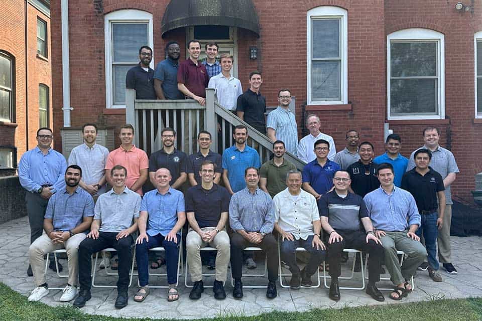 A group of Jesuit scholastics on the deck of Bellarmine House 