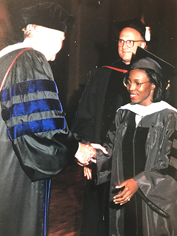 Anderson shakes hands at her 2001 SLU commencement.