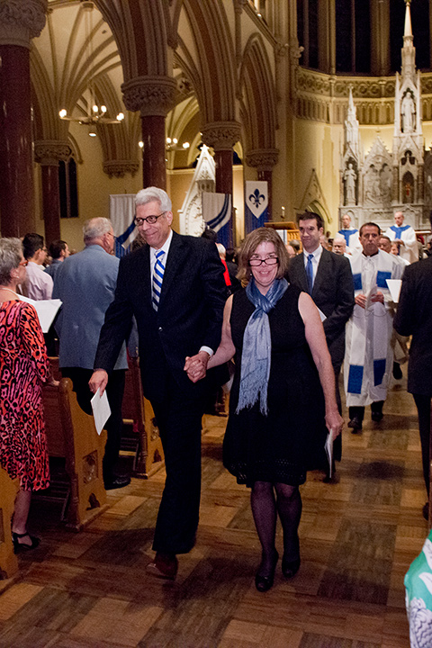 Dr. Fred Pestello and his spouse, Dr. Fran Pestello, walk hand-in-hand down the aisle of St. Francis Xavier College Church following the inauguration Mass on Oct. 2, 2014.