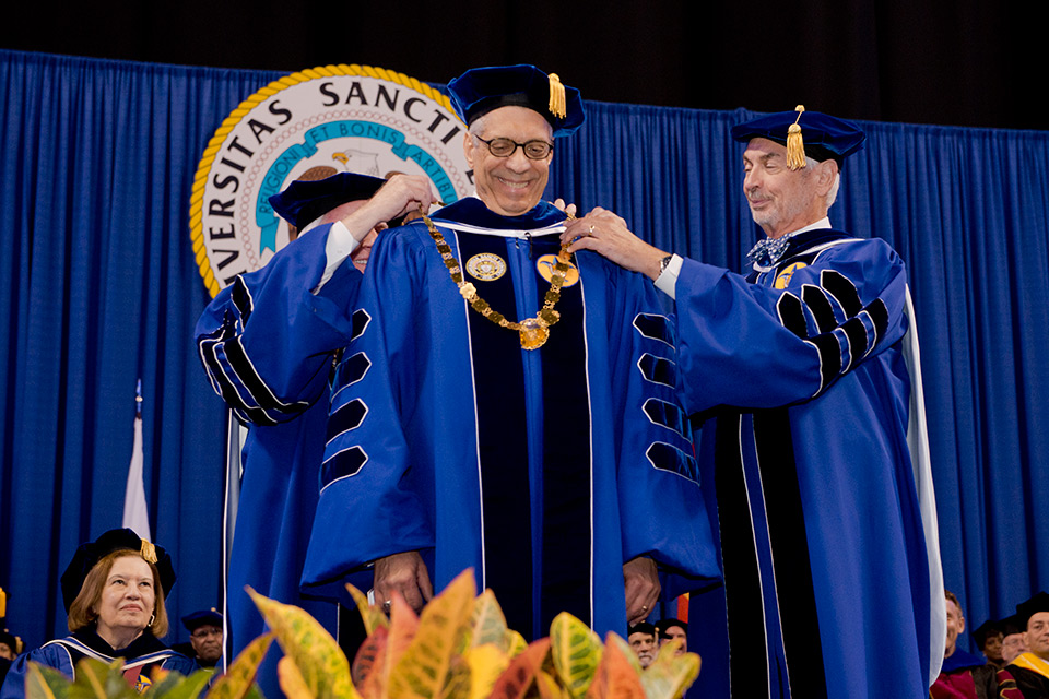 Fred Pestello receiving the chain of office from Bill Kauffman during Pestello's inauguration ceremony